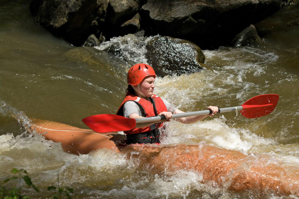 teenage girl white water kayaking